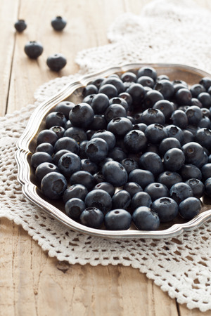 Blueberries on a silver platterの写真素材