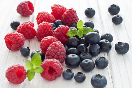 Blueberries and raspberries with mintの写真素材