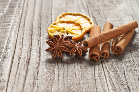 Christmas decoration with cinnamon sticks, anise and orangeの写真素材