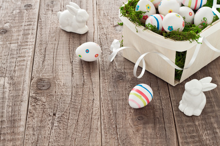 Basket with easter eggs and easter bunniesの写真素材