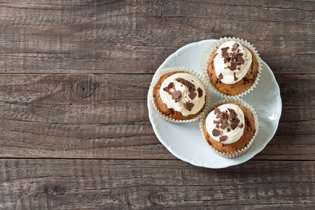 Chocolate cupcakes on a wooden tableの写真素材