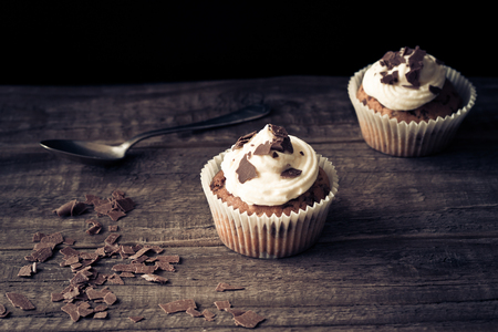 Chocolate cupcakes on a wooden tableの写真素材