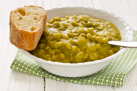 Fresh homemade pea soup with breadの写真素材