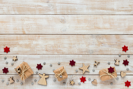 Christmas decoration with presents, snowflakes and stars on a wooden backgroundの写真素材