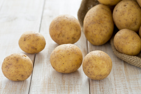 Potatoes in a burlap sackの写真素材