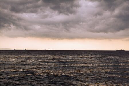 Storm clouds by the sea. Silhouettes of ships on the horizon. Adriatic sea. Italy. Seascape.の写真素材