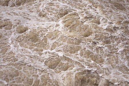Stormy sea water, rough water surface. Foaming pink water. Foam and bubbles. Magnificence and power...