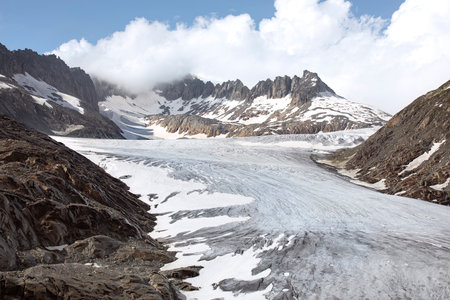Rhone glacier on the top of the mountain with visible ice surface, snow and cracks. Scenic high alps mountains arid landscape.の写真素材