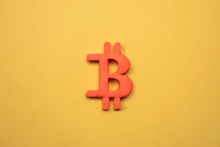 Symbol of bitcoin crypto currency. 3d Golden bitcoin sign on yellow background, bitcoin concept. Financial market and investment.の写真素材
