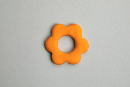 Simple three dimensional icon of flower head in bloom. Symbol of prosperity, growth concept, growing business. Orange flower sign on neutral background, environmental, gardening, horticulture topics.の写真素材