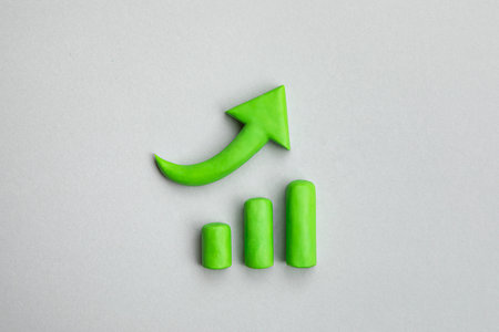 Business growth concept, 3d green arrow pointing up and chart indicating development. Three dimensional simple signs. Financial prosperity, business plan concept.の写真素材