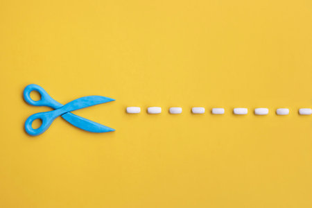 Plasticine 3d scissors with cut lines on yellow background. Concept of craft works, design or fashion, DIY tools.の写真素材