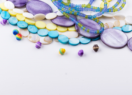 Glass and seed beads, gemstone beads on white background. Selective focus.の写真素材
