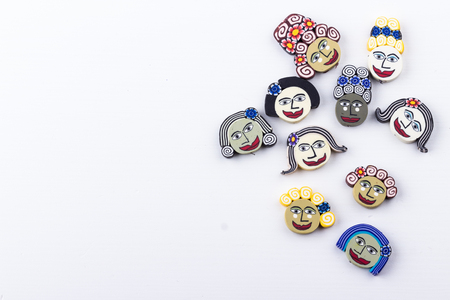 Mix bead polymer clay faces on white background. Selective focus. Top view.の写真素材
