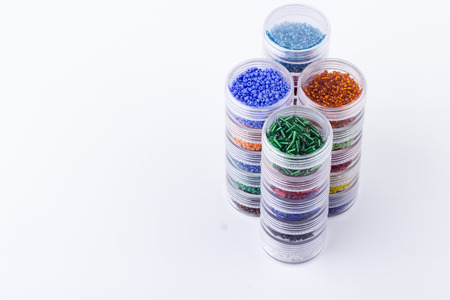Seed beads storage system. Glass seed beads in tubes for jewelry making and beading process on white background. Hobby, handmade, fine arts. Selective focus.の写真素材