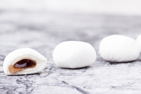 Mochi dessert with grape flavor closeup on grey background. Selective focus.の写真素材