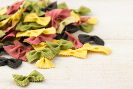 A Group of Colored Italian Farfalle Pasta on a White Tableの写真素材