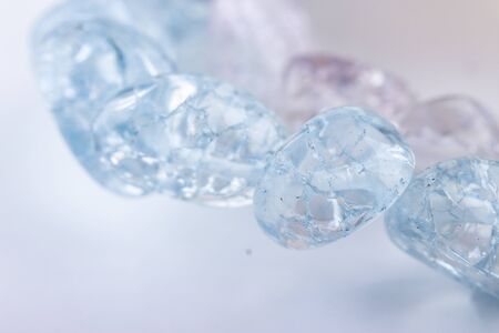 Ð¡rystal light blue beads closeup for winter handmade on white background. Selective focus.の写真素材