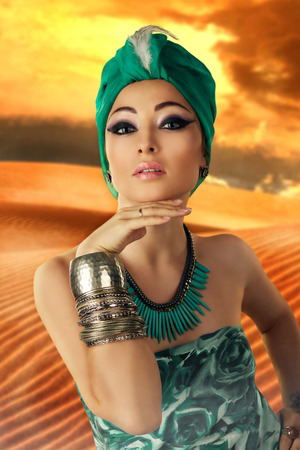 beautiful woman in oriental style in turbanの写真素材