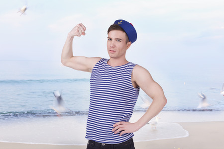 young handsome sailor in the background of the seaの写真素材