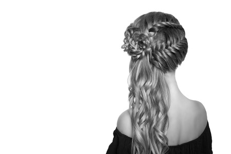 portrait of a beautiful young blonde woman on a light background with hairdo on her head. copy space.の写真素材