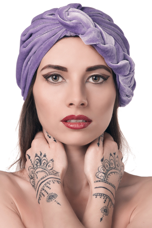 beautiful stylish woman in oriental style with mehendy wearing in turban isolated in white backgroundの写真素材
