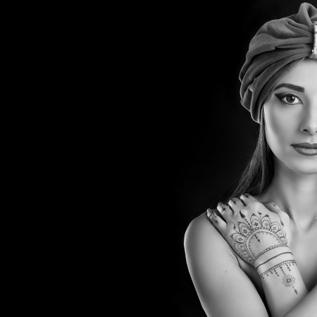 beautiful stylish woman in oriental style with mehendy wearing in turbanの写真素材