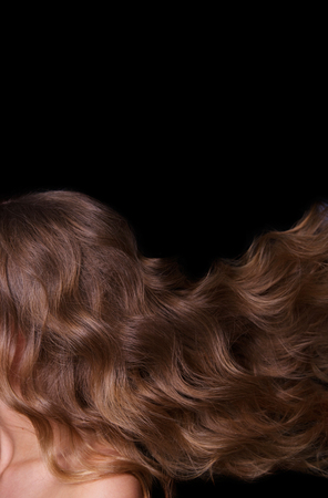 Beauty Fashion Model Woman , portrait,  hairstyle with creative hair-dress, curls waves. Concept Girl face with perfect skin in dark Backgroundの写真素材