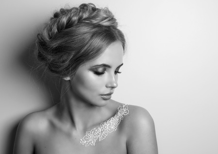 Beauty Fashion Model Woman , portrait,  hairstyle with braids. Concept Girl face with perfect skin in bright Background. Mehndi , white henna tattoo on shoulders.の写真素材