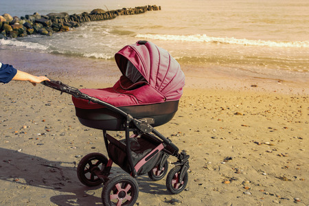 A stroller strolls in the seaside. toned photo