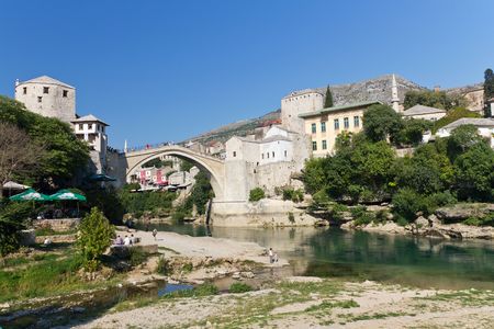 Tourists Relaxing by the River and Walking Across the Historic Old Bridge On September 24, 2010 in Mostar, Bosnia and Herzegovina のeditorial素材
