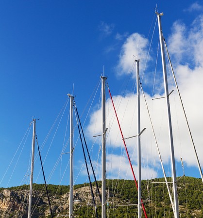 Five Sailboat Masts In Front of A Blue Sky On A Sunny Day On Vis Island, Croatiaの写真素材