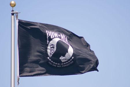 The POW/MIA flag is an American flag designed as a symbol of the citizens concern about the United States military personnel taken as prisoners of war and missing in action.の写真素材