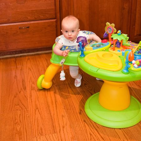 Baby walker is a device that can be used by infants who cannot walk on their own to move from one place to another.の写真素材