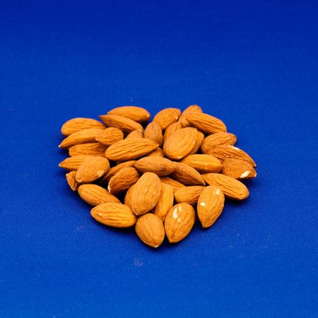 Almond is also the name of the edible and widely cultivated seed of this tree. Although popularly referred to as a nut, the almond seed or fruit is botanically not a true nut, but the seed of a drupeの写真素材