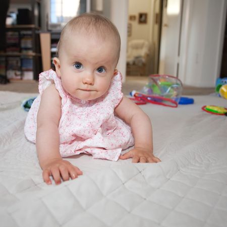Babies usually learn to crawl before they develop walking skills. For humans it usually means moving on knees and hands, with support from the toes.の写真素材
