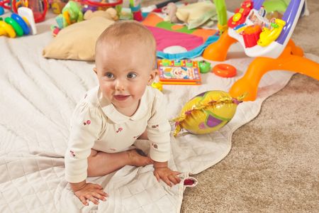 Caucasian baby girl playing on a floor.の写真素材
