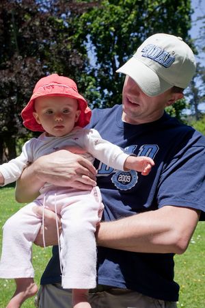 Father holding his dauther in a park.の写真素材