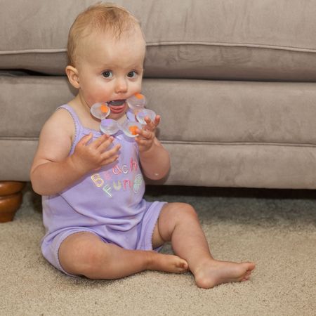 Teething is the process by which an infant's teeth sequentially appear by breaking through the gums.の写真素材