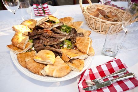 Grilled lamb ribs with pita bread and vegetables.の写真素材