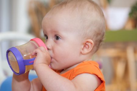 The sippy cup is a spill-proof drinking cup designed for toddlers.の写真素材