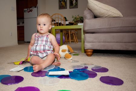 Caucasian baby girl playing on a floor.の写真素材