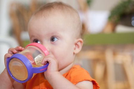 The sippy cup is a spill-proof drinking cup designed for toddlers.の写真素材
