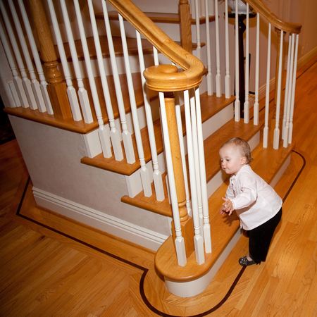 Cute Caucasian baby girl playing on a floor.の写真素材
