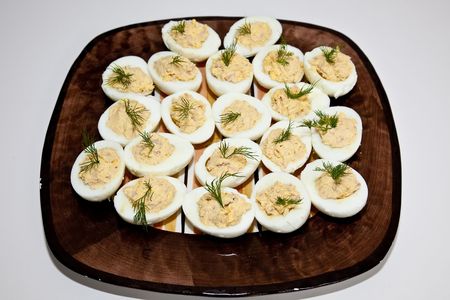 Deviled eggs or eggs mimosa are hard-boiled eggs cut in half and filled with the hard-boiled egg's yolk mixed with different ingredients. Deviled eggs are usually served cold. They are served as a side dish, appetizer or a main course, and are a common hoの写真素材