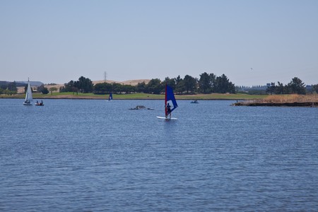 Various recreational sailing vessels on artificial lake in a parkの写真素材