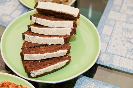 Slices of traditional Polish gingerbread on green plate.