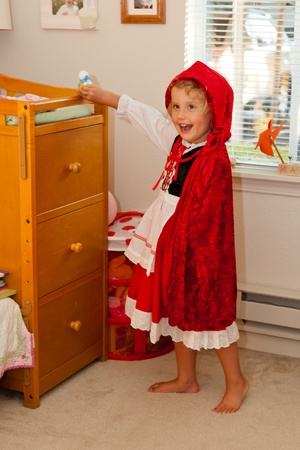 Trying a Little Red Riding Hood costume before Halloweenの写真素材