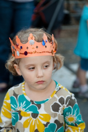 Wearing hand made orange paper crown during harvest festival.の写真素材