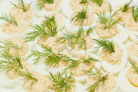 Deviled eggs or eggs mimosa are hard-boiled eggs cut in half and filled with the hard-boiled egg's yolk mixed with different ingredients. Deviled eggs are usually served cold. They are served as a side dish, appetizer or a main course, and are a common hoの写真素材